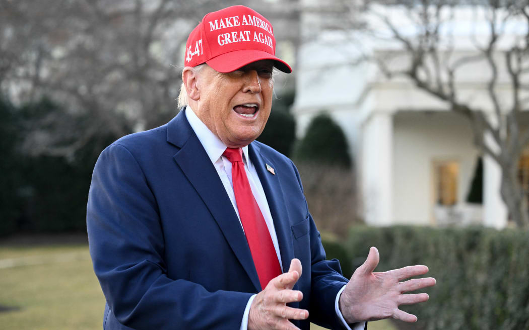 US President Donald Trump gestures as he speaks to reporters as he prepares to depart the White House in Washington, DC, on February 28, 2025, en route to his Mar-a-Lago resort in Palm Beach, Florida. (Photo by SAUL LOEB / AFP)