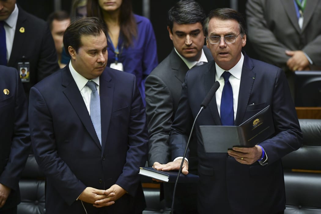 Jair Bolsonaro (R) swears in as Brazil's new President.