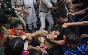 Indian wrestlers Sangeeta Phogat, left, and Vinesh Phogat, centre, are detained by the police while attempting to march to India's new parliament during a protest against Brij Bhushan Singh, the wrestling federation chief, over allegations of sexual harassment and intimidation, in New Delhi on 28  May, 2023.