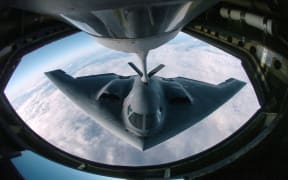(FILES) This 4 April, 2005 Department of Defense handout image shows a B-2 Spirit multi-role bomber conducting air refueling operations with a KC-135 Stratotanker over the Pacific Ocean. US stealth bombers were flying on June 21, 2025 across the Pacific Ocean, according to tracking data and media reports, fueling speculation over their intended mission as President Donald Trump considers joining Israel's attack on Iranian nuclear sites. Multiple B-2 bomber aircraft left a base in the central United States overnight and were later tracked flying off the California coast along with aerial refueling jets, The New York Times and specialist plane tracking sites reported. (Photo by US Department of Defense / AFP) / RESTRICTED TO EDITORIAL USE - MANDATORY CREDIT "AFP PHOTO /  US DEPARTMENT OF DEFENSE"- NO MARKETING NO ADVERTISING CAMPAIGNS - DISTRIBUTED AS A SERVICE TO CLIENTS