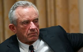 Robert F Kennedy Jr - a 71 year old man with cropped grey hair - wears a suit and looks to the side.