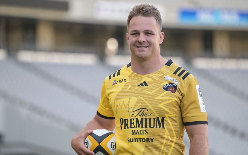 New Zealand All Blacks captain Sam Cane poses in his new Suntory Sungoliath uniform, 2023.