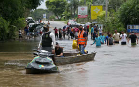A member of the Navy helping to transport and empty coffin from Ilheus to the Costa do Cacau Regional Hospital in Itabuna, during floods.
