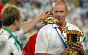 England's Jonny Wilkinson offers the lid of the Rugby World Cup to coach Clive Woodward after winning the 2003 tournament.