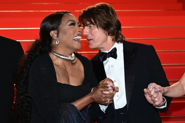 US actress Angela Bassett speaks with US actor and producer Tom Cruise as they leave after the screening of the film "Mission: Impossible - The Final Reckoning" at the 78th edition of the Cannes Film Festival in Cannes, southern France, on May 14, 2025. (Photo by Miguel Medina / AFP)