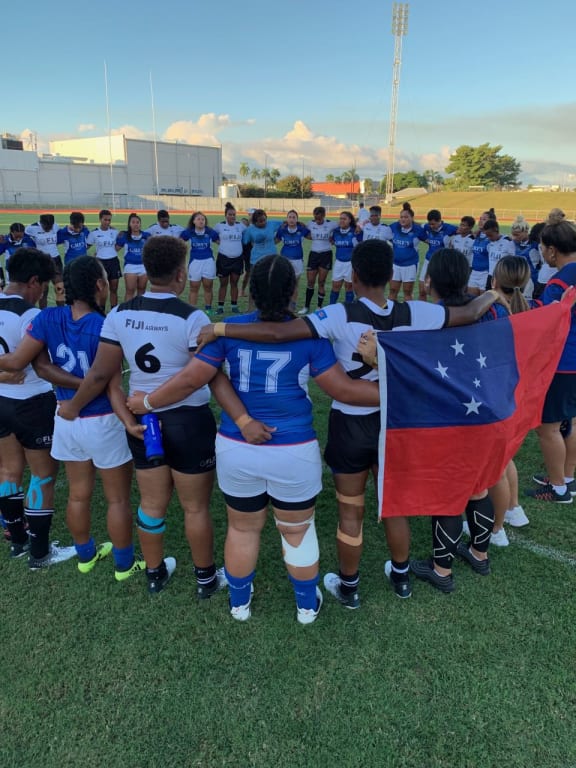 Fiji and Samoa players come together for a post-match prayer.