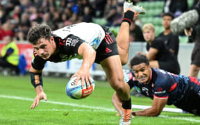 Crusaders winger Macca Springer scores a try against the Melbourne Rebels.