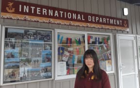 International student Akira Myojo, from Japan, in front of the International Department at Cashmere College