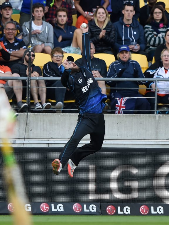 Daniel Vettori leaps high to catch Marlon Samuels out.