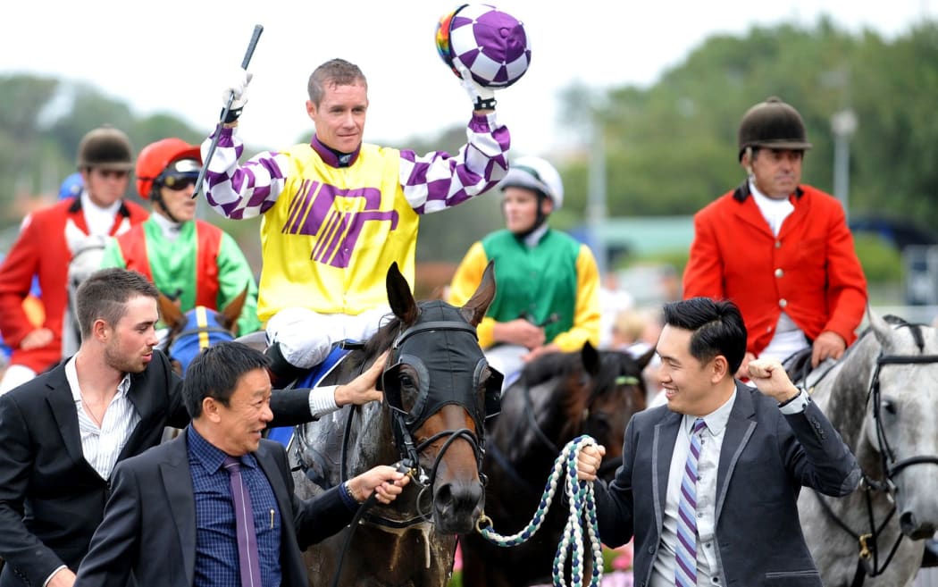 Jockey Mark Du Plessis celebrates after winning the Auckland Cup on Rock Diva at Ellersie.