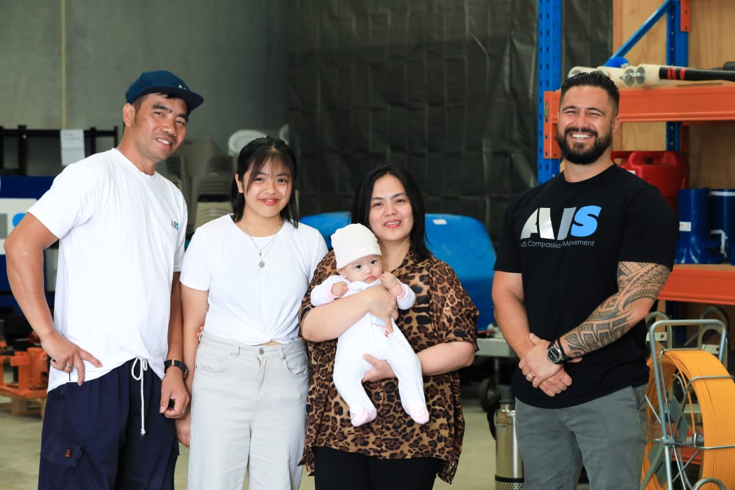 Joel Macarubbo, Tarri Caraquez and their children Jeomille, 15, and Beau, four months, with Joel's new employer, Mike Milligan, co-founder of AIS Global.