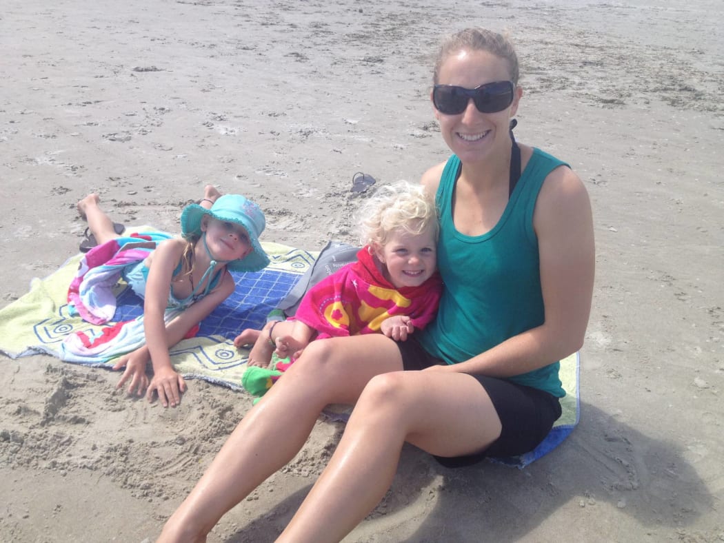 Sharlene Kelly and her daughters on a beach