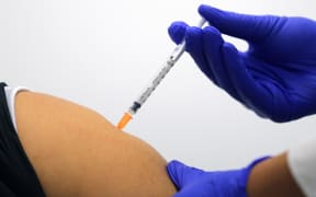 A woman receives a dose of the Pfizer/BioNTech Covid-19 vaccine during the first rollout in Australia at the Castle Hill Medical Centre in Sydney on February 21, 2021.