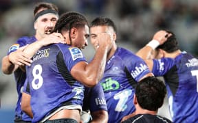 Hoskins Sotutu is congratulated after scoring during the round 9 Super Rugby Pacific match between the Blues and Brumbies at Eden Park.
