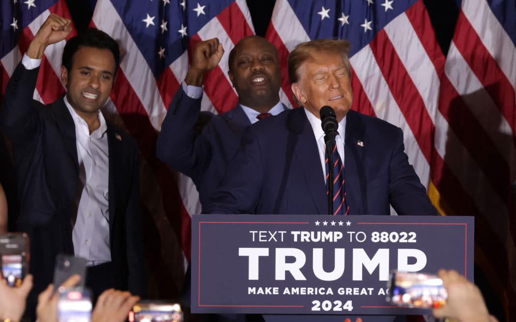 Former US President Donald Trump delivers remarks alongside Vivek Ramaswamy (L) and U.S. Sen. Tim Scott (R-SC) during his primary night rally at the Sheraton on January 23, 2024 in Nashua, New Hampshire.