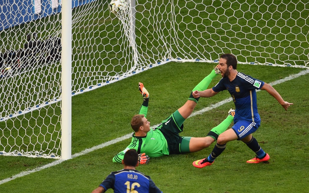 Argentina forward Gonzalo Higuain (right) shoots and scores a disallowed goal in the first half.