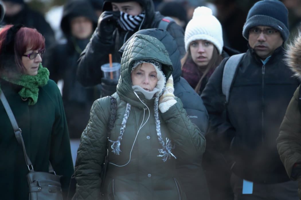 Commuters brave sub-zero temperatures as they make their way to work in the Loop on January 2, 2018 in Chicago, Illinois.