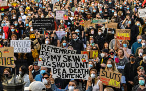 Demonstrators attend a Black Lives Matter protest to express solidarity with US protestors in Sydney on June 6, 2020 and demand an end to frequent Aboriginal deaths in custody in Australia.