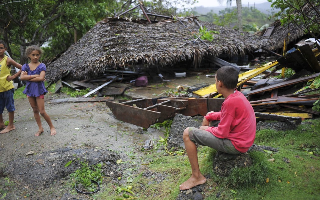 Children are seen before damaged property in the Carbonera community of Guantanamo, Cuba following Hurricane Matthew.