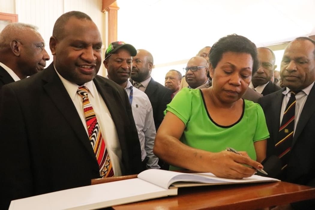 James Marape and his wife Rachael Marape signing the visitors book at Government House after arriving for his swearing in as Prime Minister of PNG.