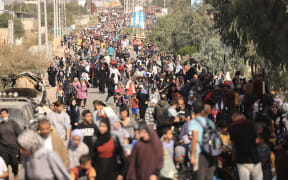 Palestinians families fleeing Gaza City and other parts of northern Gaza towards the southern areas, walk along a highway on November 9, 2023, amid the ongoing battles between Israel and the Palestinian Islamist group Hamas.