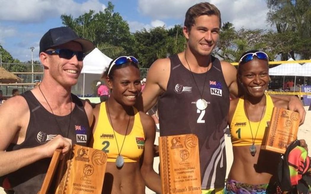 Vanuatu Volleyball Linline Matauatu and Miller Pata celebrate winning gold at the Oceania Beach Volleyball Championship, with coach and men's gold medalist Jason Lochhead [L]