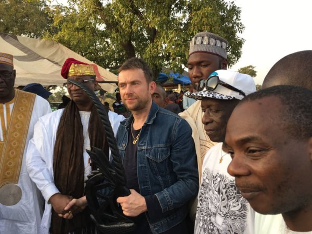 picture of British musician Damon Albarn being granted the status of a local king in the village of Kirina, Mali.