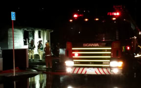 Fire engines fight the blaze at a two-story block of flats in Johnsonville, Wellington