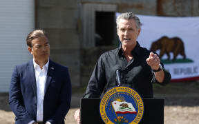 CERES, CALIFORNIA - APRIL 16: California Governor Gavin Newsom (R) speaks as California Attorney general Rob Bonta looks on during a news conference at Gemperle Orchard on April 16, 2025 in Ceres, California. Governor Gavin Newsom and California Attorney General Rob Bonta have filed a lawsuit in federal court challenging the Trump administration's use of emergency powers to enact sweeping tariffs that hurt states, consumers, and businesses. The tariffs have disrupted supply chains, increased costs for the state and Californians, and inflicted billions in damages on California’s economy, the fifth largest in the world.   Justin Sullivan/Getty Images/AFP (Photo by JUSTIN SULLIVAN / GETTY IMAGES NORTH AMERICA / Getty Images via AFP)