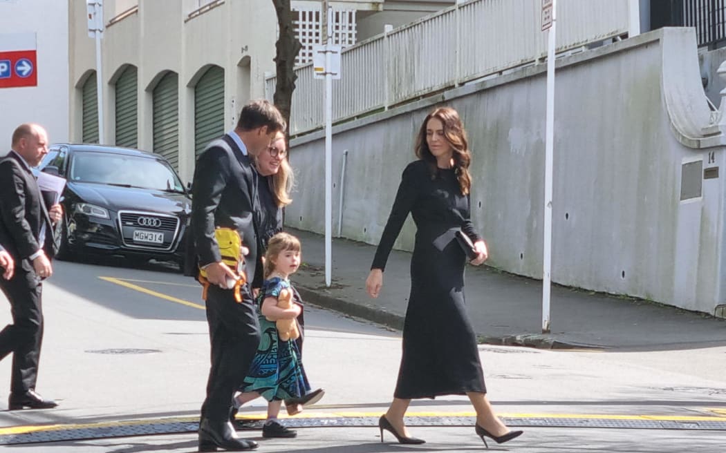 Prime Minister Jacinda Ardern, partner Clarke Gayford and daughter Neve arrive at the state memorial service for the Queen.