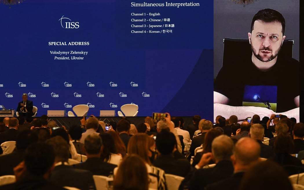Ukraine's President Volodymyr Zelensky (on screen) addresses participants at the Shangri-La Dialogue summit virtually via a video link in Singapore on 11 June 2022.