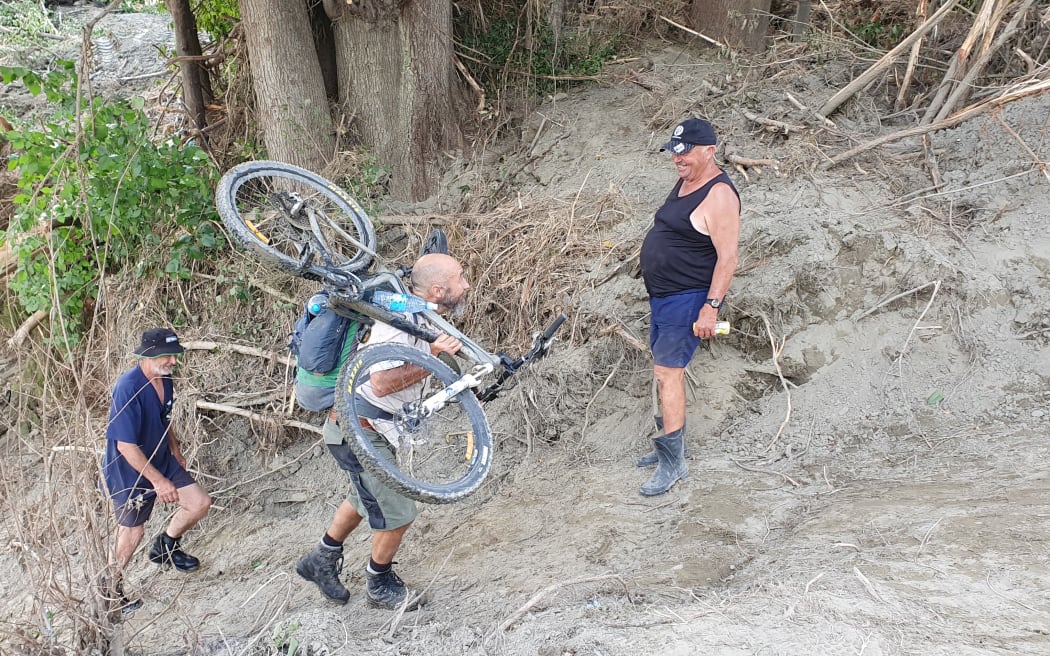 All sorts are being carried across, and up the high sandy riverbank to the road on the Rissington side.