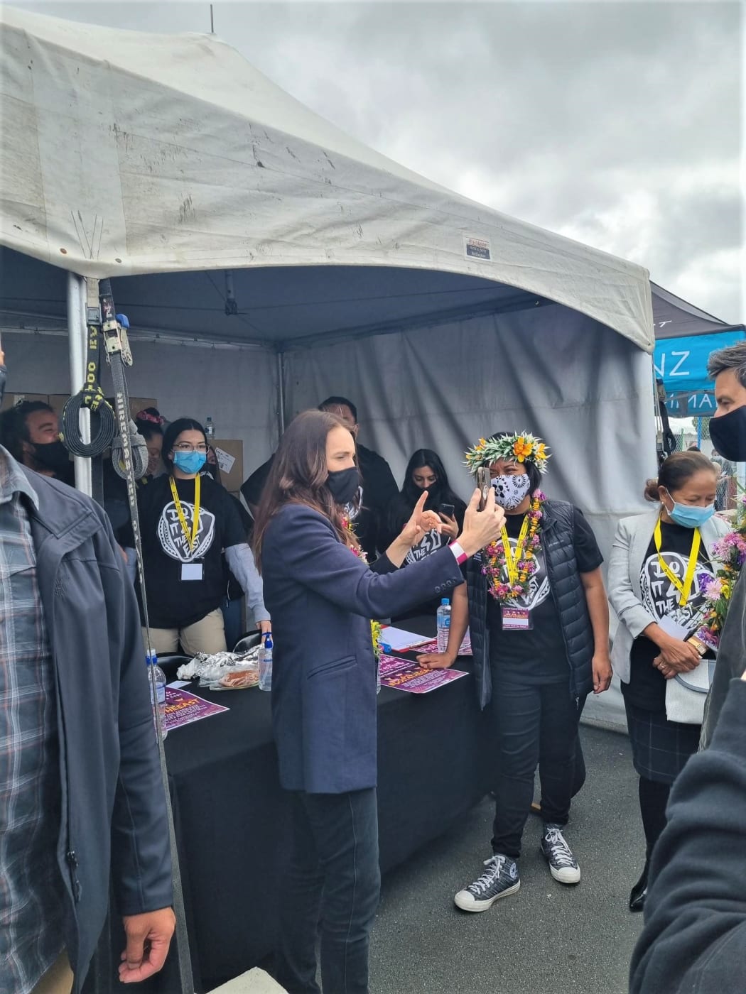 Prime Minister Jacinda Ardern taking a selfie with some of the organizers of ‘Do it 4 the East’, a youth-led vaccination event in Porirua.