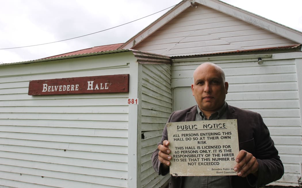 Belvedere Hall in Carterton is on the market. Council communications and engagement manager Marcus Anselm is pictured holding a placard outside the front of the building last year.