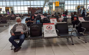 Passengers wait for flights in the Heathrow Airport in London.