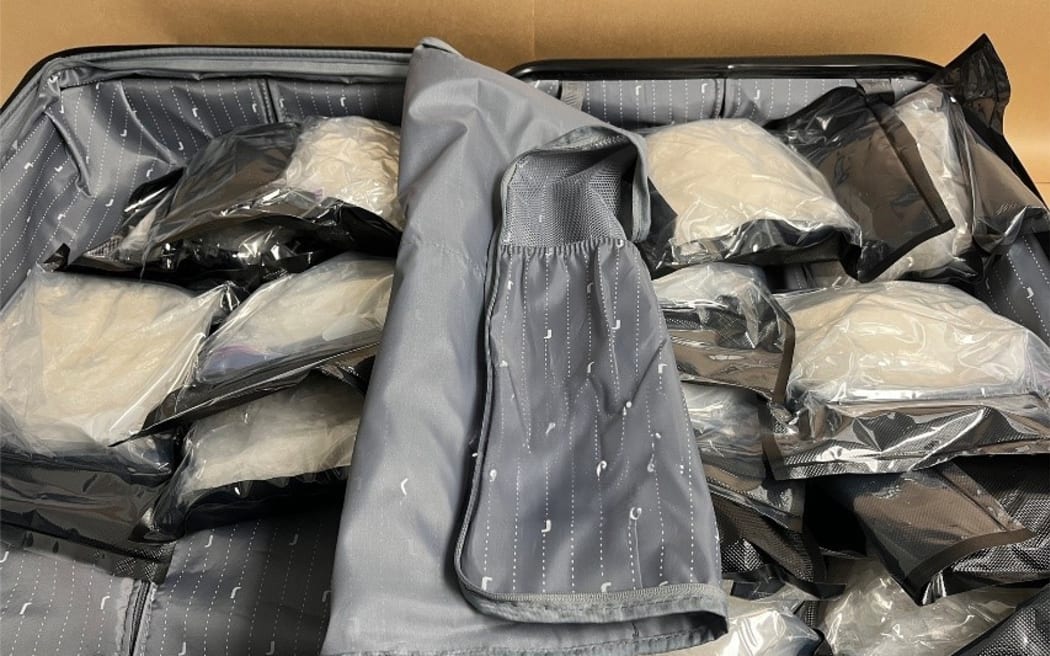 Suitcase containing 14 individually vacuum-sealed packages of methamphetamine.