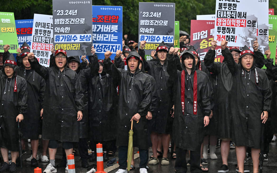 Members of the National Samsung Electronics Union stage a rally as they begin a three-day general strike outside the company's foundry and semiconductor factory in Hwaseong on July 8, 2024. Workers at South Korean tech giant Samsung began a three-day general strike over pay and benefits on July 8, the head of a union representing tens of thousands of employees told AFP, warning the action could impact key memory chip production.
