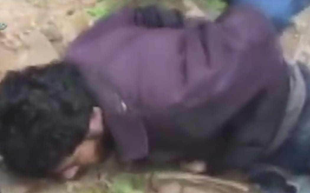 Amateur video shows refugees or migrants in Strandja, Bulgaria having their hands tied behind their backs as they lie in a wood.
