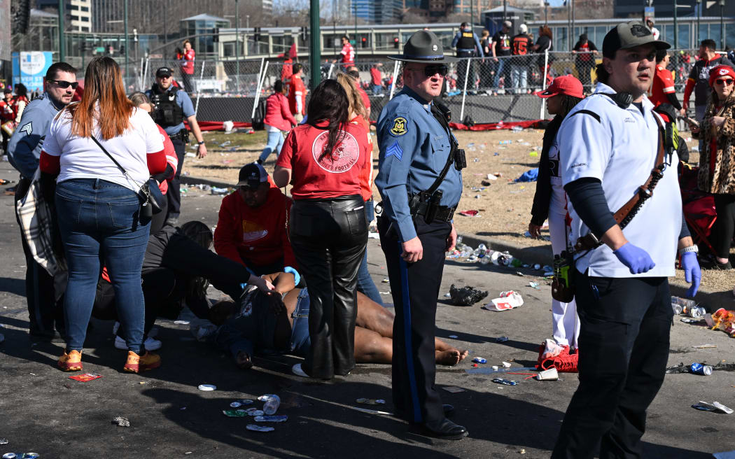 An injured person is helped near the Kansas City Chiefs' Super Bowl LVIII victory parade on February 14, 2024, in Kansas City, Missouri. Shots were reportedly fired during the parade, according to police. (Photo by ANDREW CABALLERO-REYNOLDS / AFP)