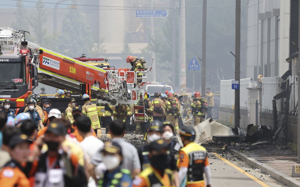 Firefighters work at the site of a burnt lithium battery manufacturing factory in Hwaseong, South Korea, Monday. June 24, 2024. (Hong Ki-wonj/Yonhap via AP)