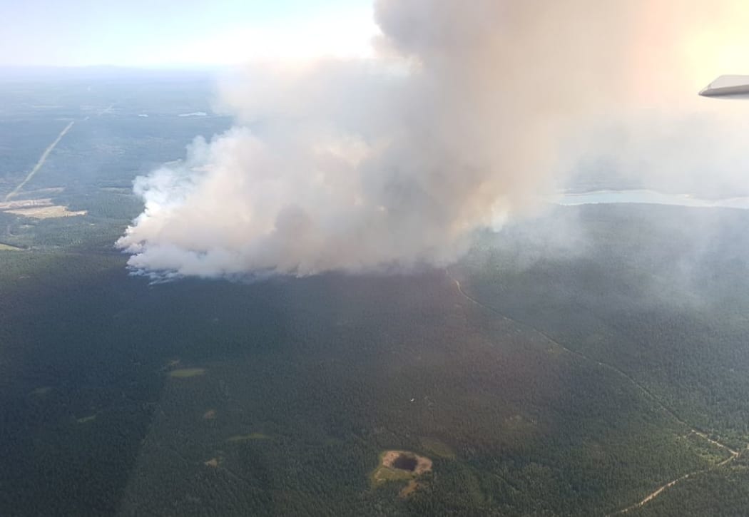 A wildfire seen burning near the town of 100 Mile House.
