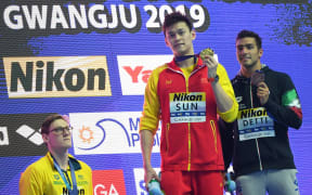 Silver medallist Australia's Mack Horton (left) refuses to stand on the podium with gold medallist China's Sun Yang (centre) and bronze medallist Italy's Gabriele Detti after the final of the men's 400m freestyle at the 2019 World Championships in South Korea.