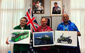 People’s Republic of China (PRC) ambassador to New Zealand, Cook Islands and Niue, Wang Xiaolong, with Cook Islands Prime Minister Mark Brown and Assistant to the Minister responsible for the Prime Minister, Sonny Williams, with placards showing the China-funded inter-island vessel, electric bus and E-motorcycle. X/WANGXIALONG/25080604