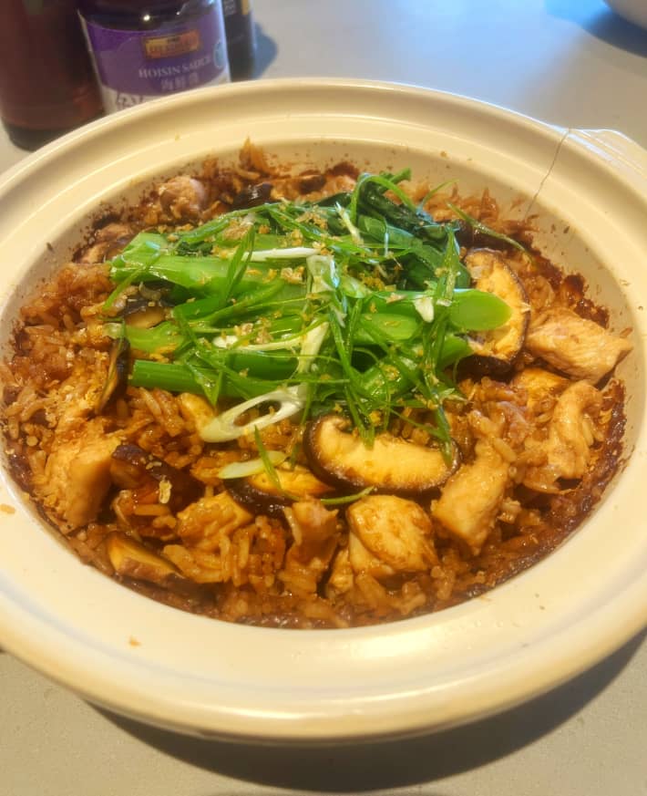 Claypot chicken garnished with spring onions.