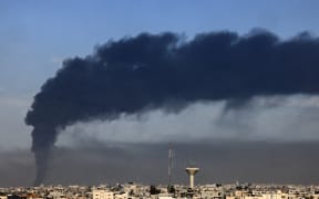 A picture taken from Rafah shows smoke billowing over Khan Yunis in the southern Gaza Strip during Israeli bombardment on January 21, 2024, amid ongoing battles between Israel and the Palestinian militant group Hamas. (Photo by AFP)