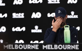 Serbia's Novak Djokovic speaks during a press conference after retiring from his men's singles semi-final match against Germany's Alexander Zverev on day thirteen of the Australian Open tennis tournament in Melbourne on January 24, 2025. (Photo by Adrian Dennis / AFP) / -- IMAGE RESTRICTED TO EDITORIAL USE - STRICTLY NO COMMERCIAL USE --