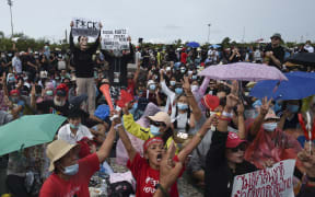 An anti-government protester holds up a three-finger salute during an anti-government protest at the Royal Ground of Sanam Luang in Bangkok, Thailand, 19 September 2020.  (Photo by Anusak Laowilas/NurPhoto)