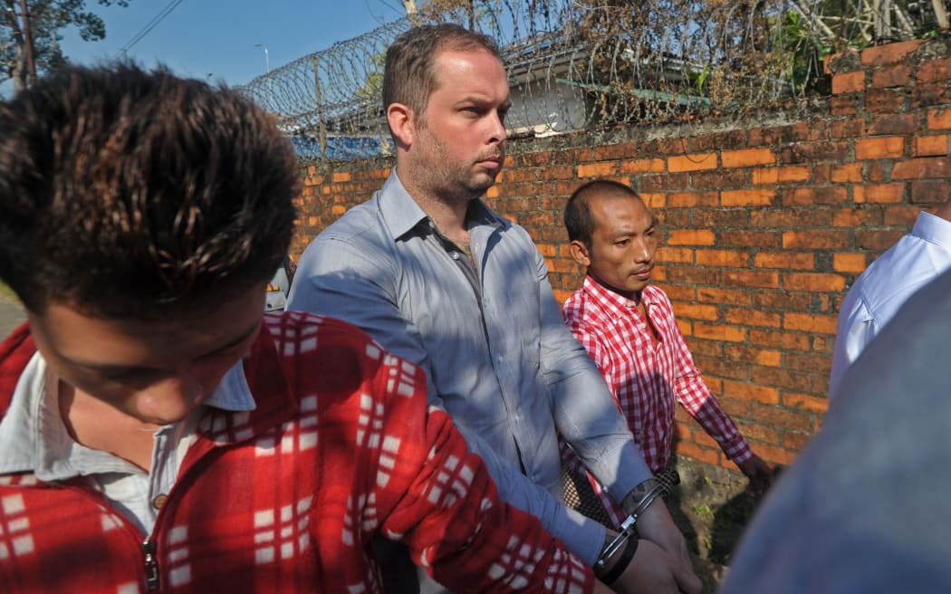 Philip Blackwood, centre, being brought to a Yangon court on 18 December.