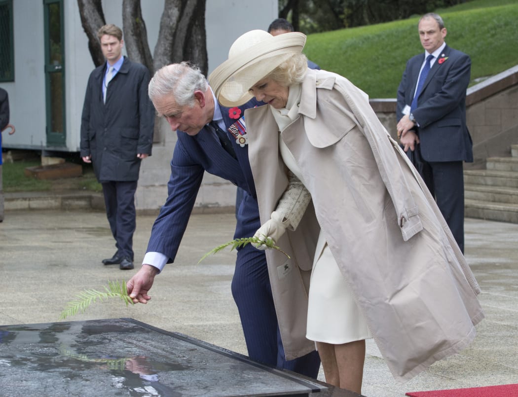 Prince Charles and the Duchess of Cornwall placed ferns on the Tomb of the Unknown Warrior - although the wind did its best to blow them away.