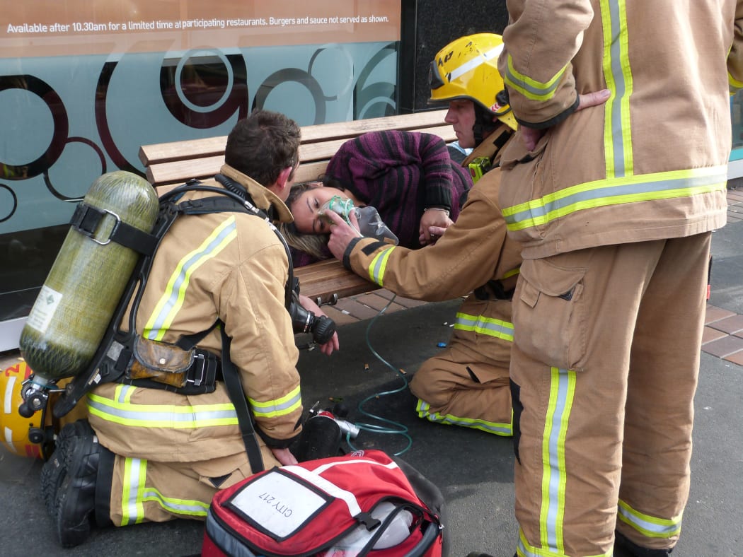A woman being attended by fire fighters opposite Wellington railway station.